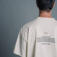 Person wearing a Natural RAW t-shirt with text on the back against a gray background